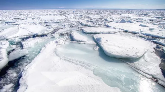 Hokkaido drift ice landscape with frozen sea and ice chunks under blue sky