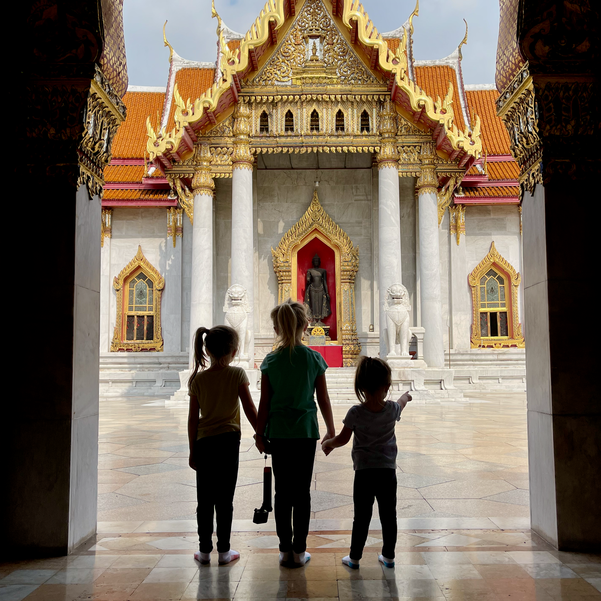 The three Clarkson girls silhouetted at a temple in Bangkok